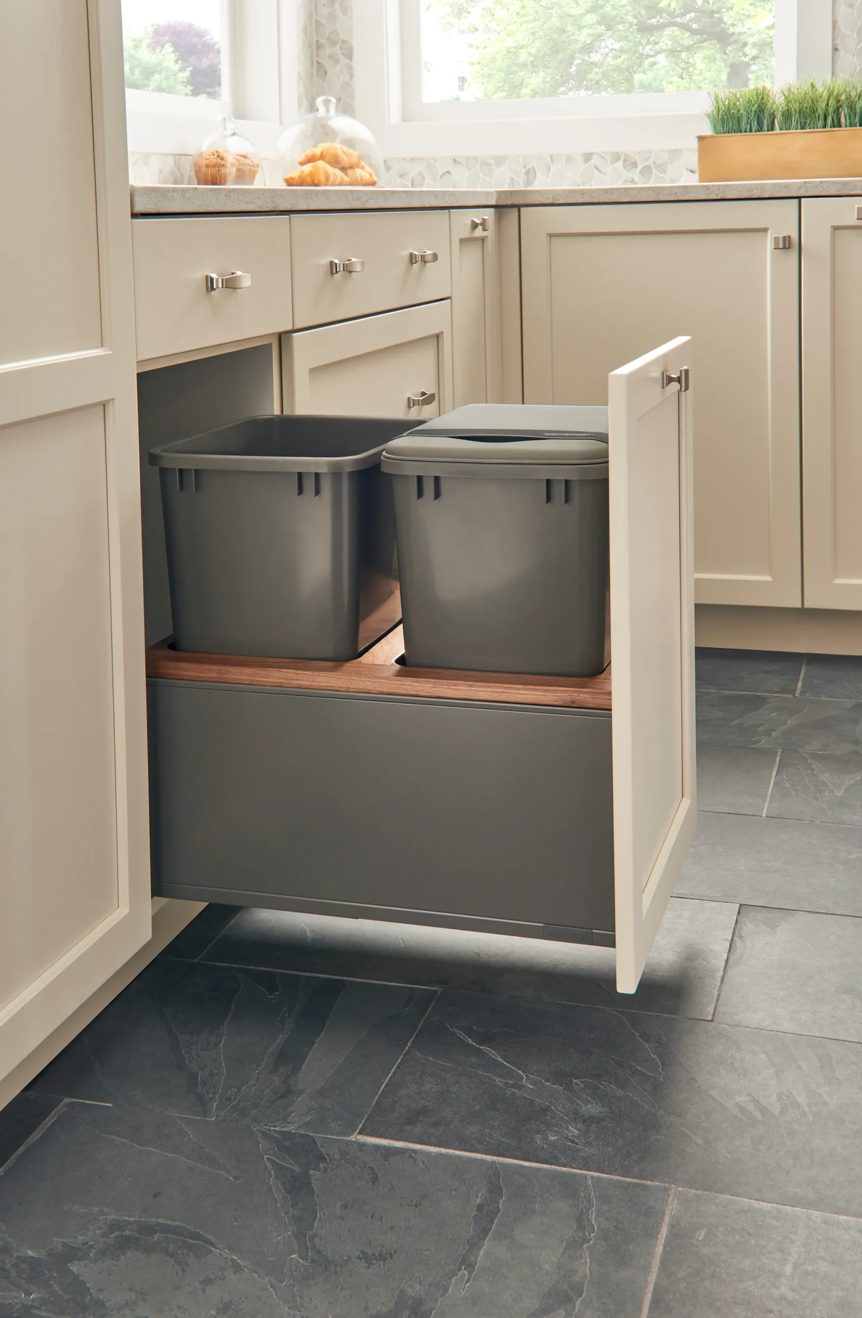 Rev-A-Shelf Legrabox pull-out waste bin in a modern kitchen decor